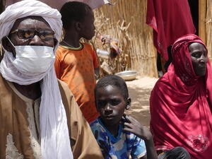 Chad. A family of internal displaced persons in Forkolom site, in front of their homes (4)