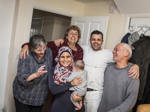 Hani Arnout, 34, and his wife Ameh, 23, share a joke with friends at home in Ottery St Mary, Devon, south-west England.