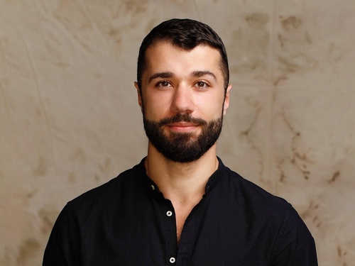 Ahmad Joudeh, High Profile Supporter for UNHCR, UN Refugee Agency looking at camera in a studio setting.