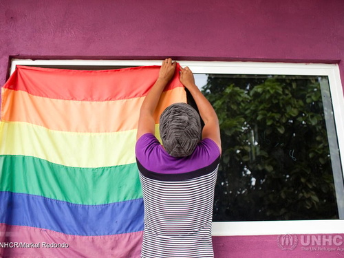 Electra and LGBT refugee from Honduras hanging up the rainbow flag at the LGBT module at La 72 migrant shelter in Tenosique, Tabasco, Mexico.