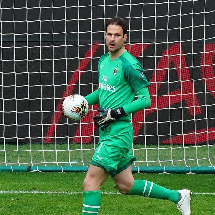 Asmir Begovic holding a football and running in front of the goal