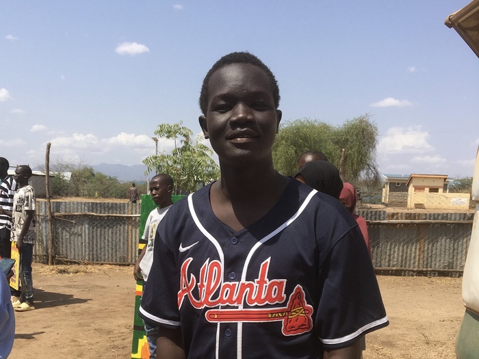 A man poses outside in Kakuma Camp, Kenya