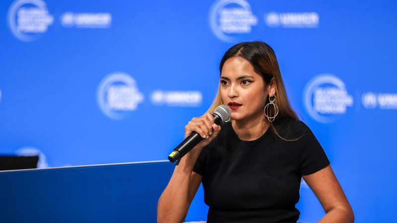 Noor Azizah, a Rohingya refugee leader, speaks into a microphone. 