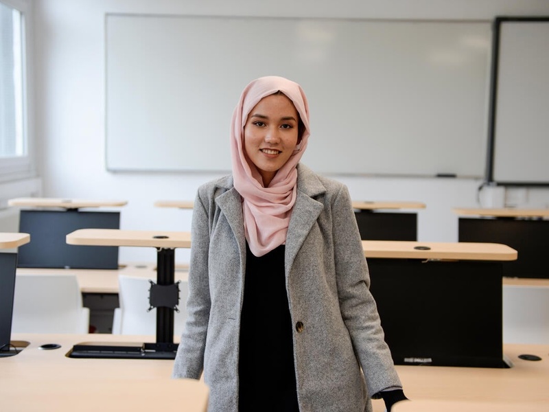 Masomah standing in her classroom.