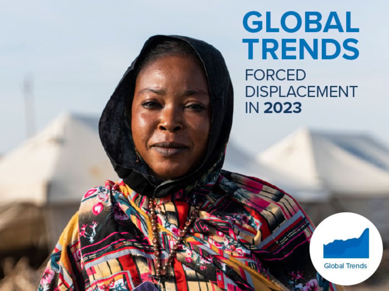 Cover of the Global Trends 2023 report featuring a woman in an IDP camp.