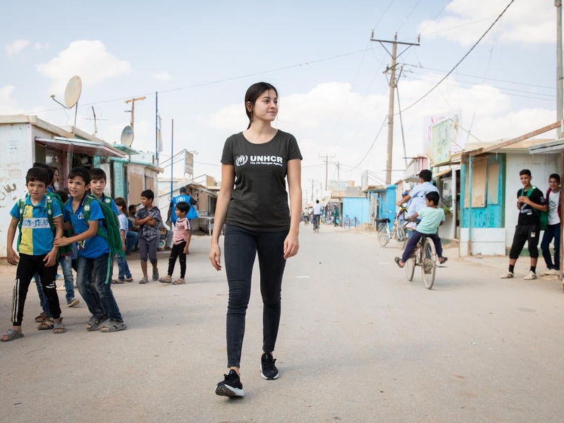 UNHCR Goodwill Ambassador Yusra Mardini walks the main market street, the Champs Elysees, in the Zaatari refugee camp in Jordan. 