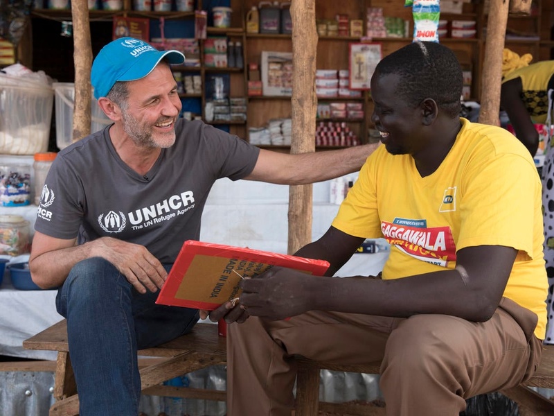 UNHCR Goodwill Ambassador Khaled Hosseini with South Sudanese refugee and entrepreneur, Jacob, at the market in Nyumanzi refugee settlement. 