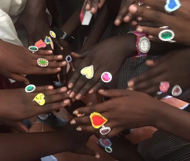 A close up of hands with heart shaped jewellery
