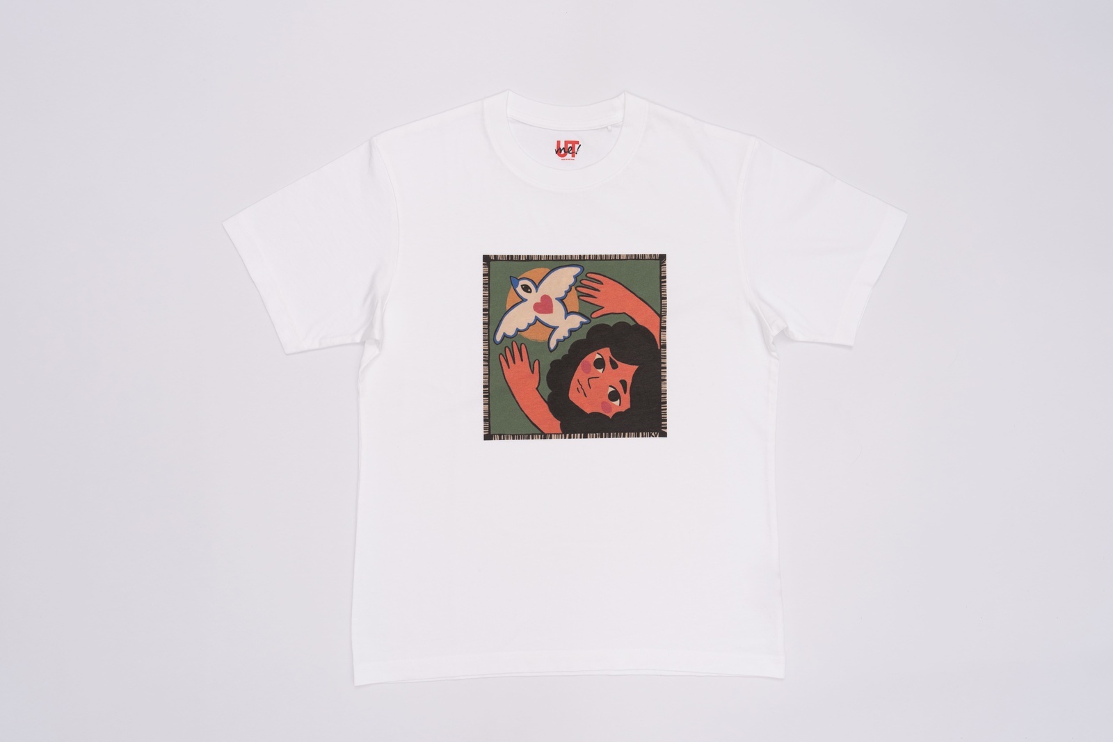 A white t-shirt with an illustration of a young girl and a white bird.