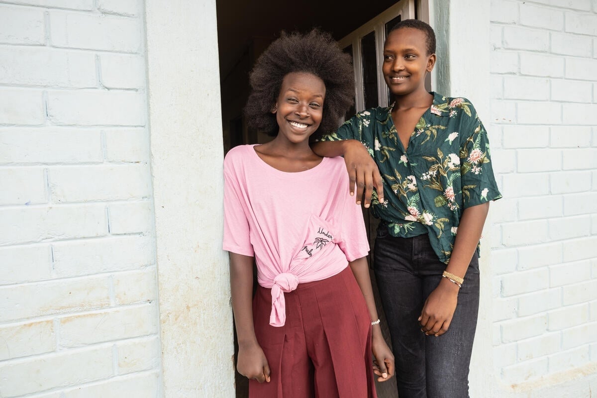 Two smiling sisters wearing clothing donated by Inditex