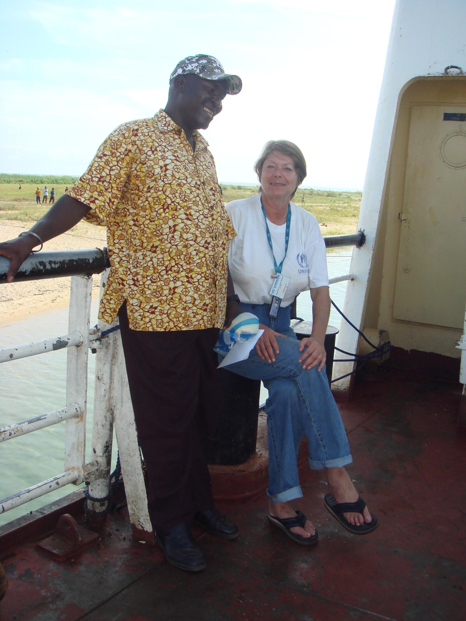 Maggie Heraty sails across Lake Tanganyika, working with a local colleague to supervise the unloading of returnee baggage in the Democratic Republic of the Congo.
