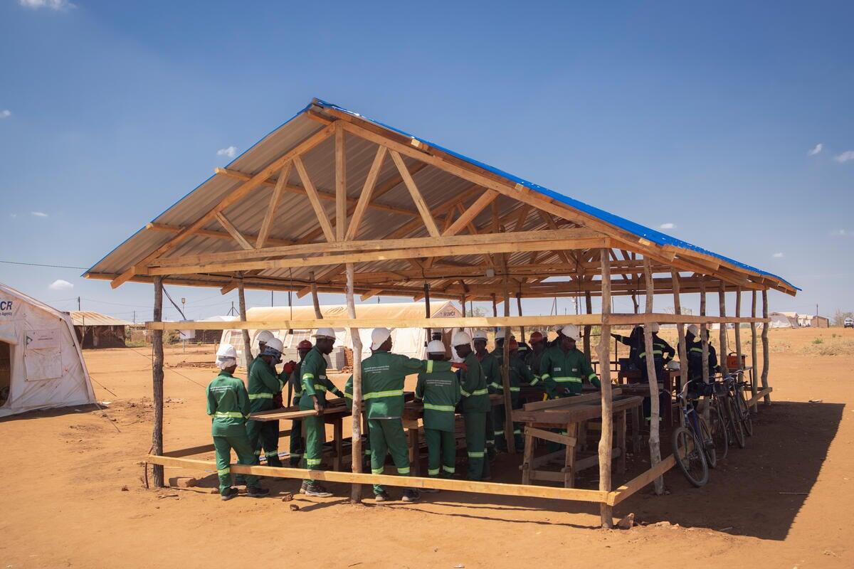 La instalación eléctrica en el asentamiento ha permitido a los residentes aprender a utilizar sierras mecánicas y otras herramientas de construcción.