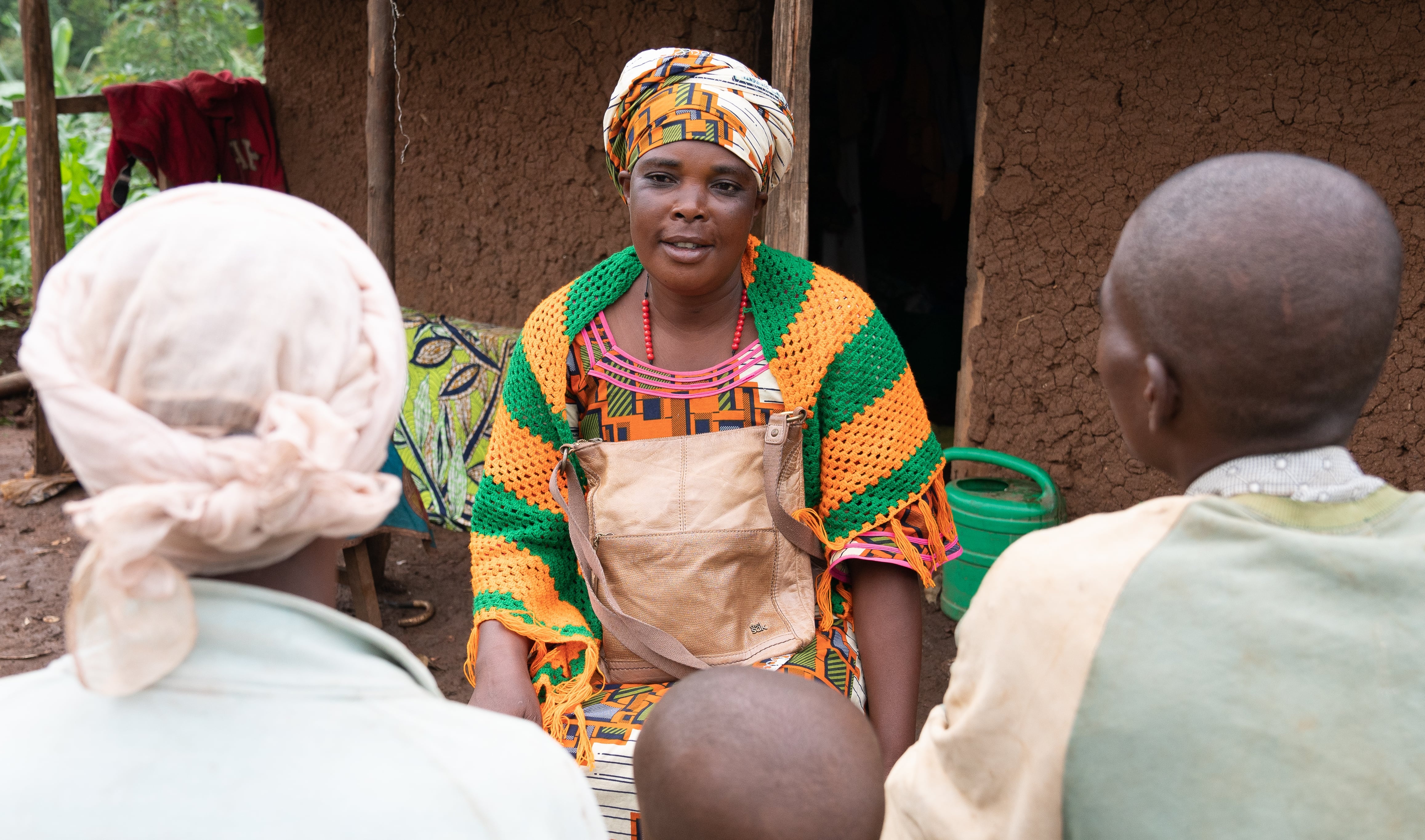 A woman sits opposite a couple.