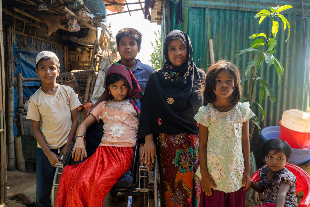 A woman and her five children pose for a photo