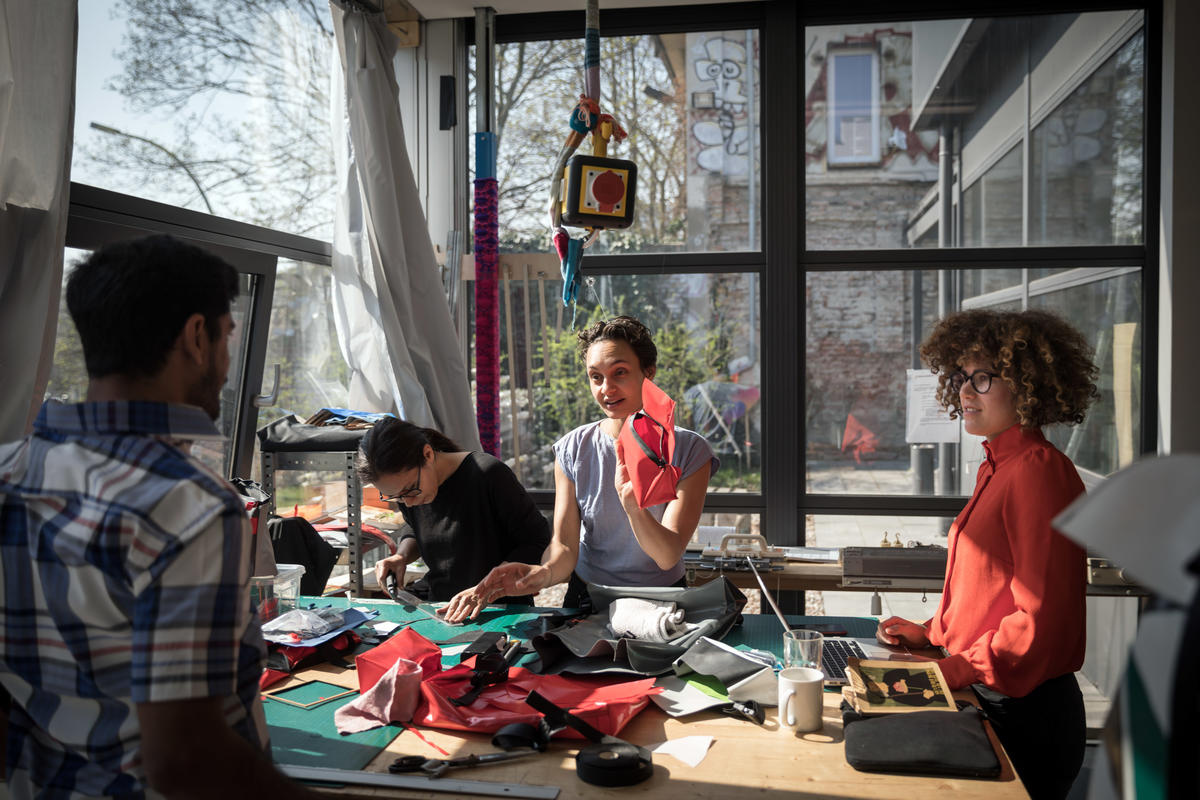 Germany. A non-profit initiative is employing newcomers to upcycle broken refugee boats into thought-provoking products.