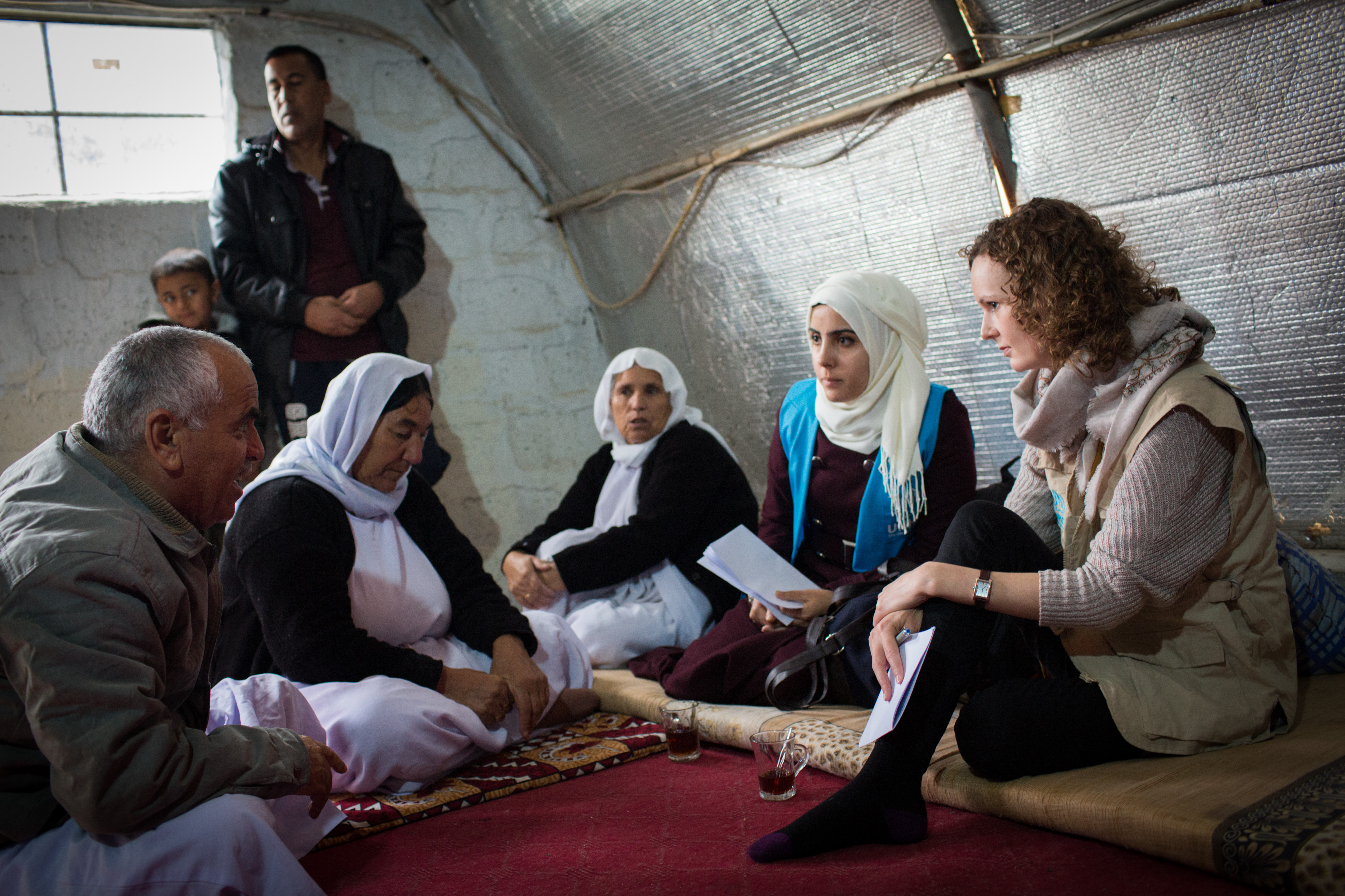 UNHCR protection officer, Gemma Woods, talks to a displaced Iraqi family who were living in a dis-used building on a university campus in northern Iraq.