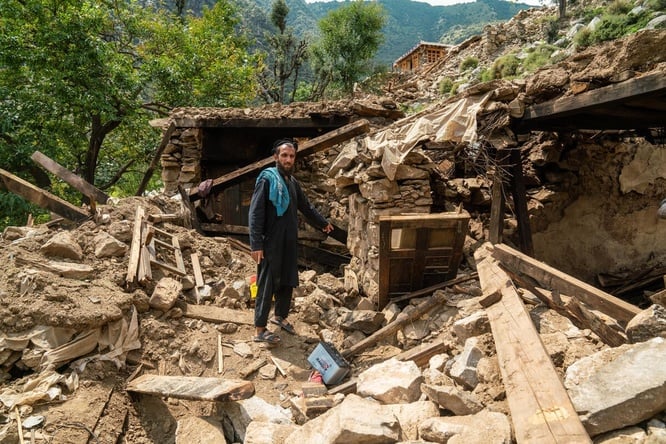 A man points at the rubble of his home following an earthquake in Kunar province, eastern Afghanistan.