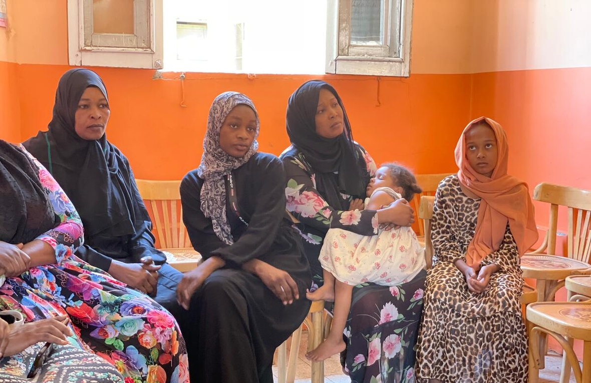 Sudanese women and children sit in a waiting room at Aswan train station.