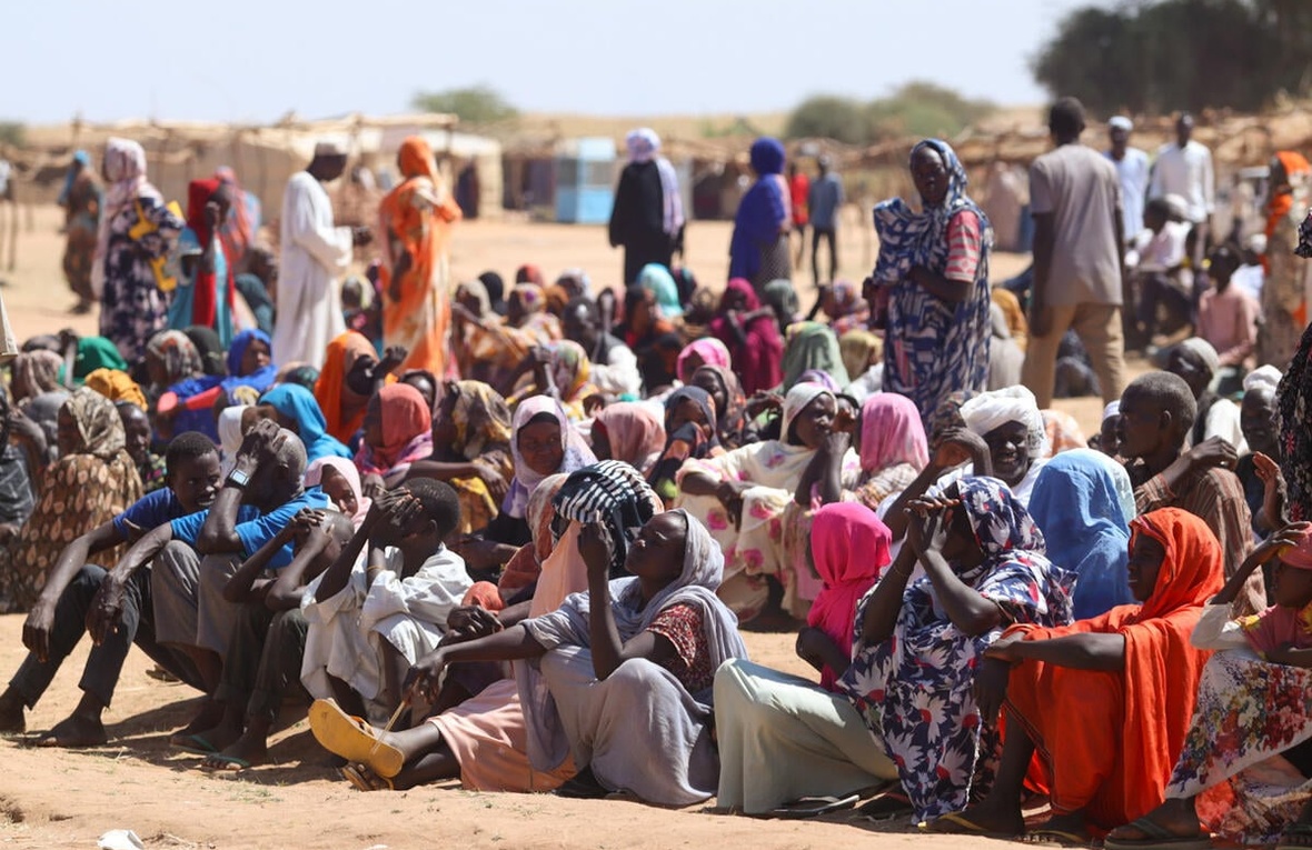 People who recently fled fighting in El Fasher and surrounding areas wait for assistance in Tawila, in Sudan's North Darfur State.