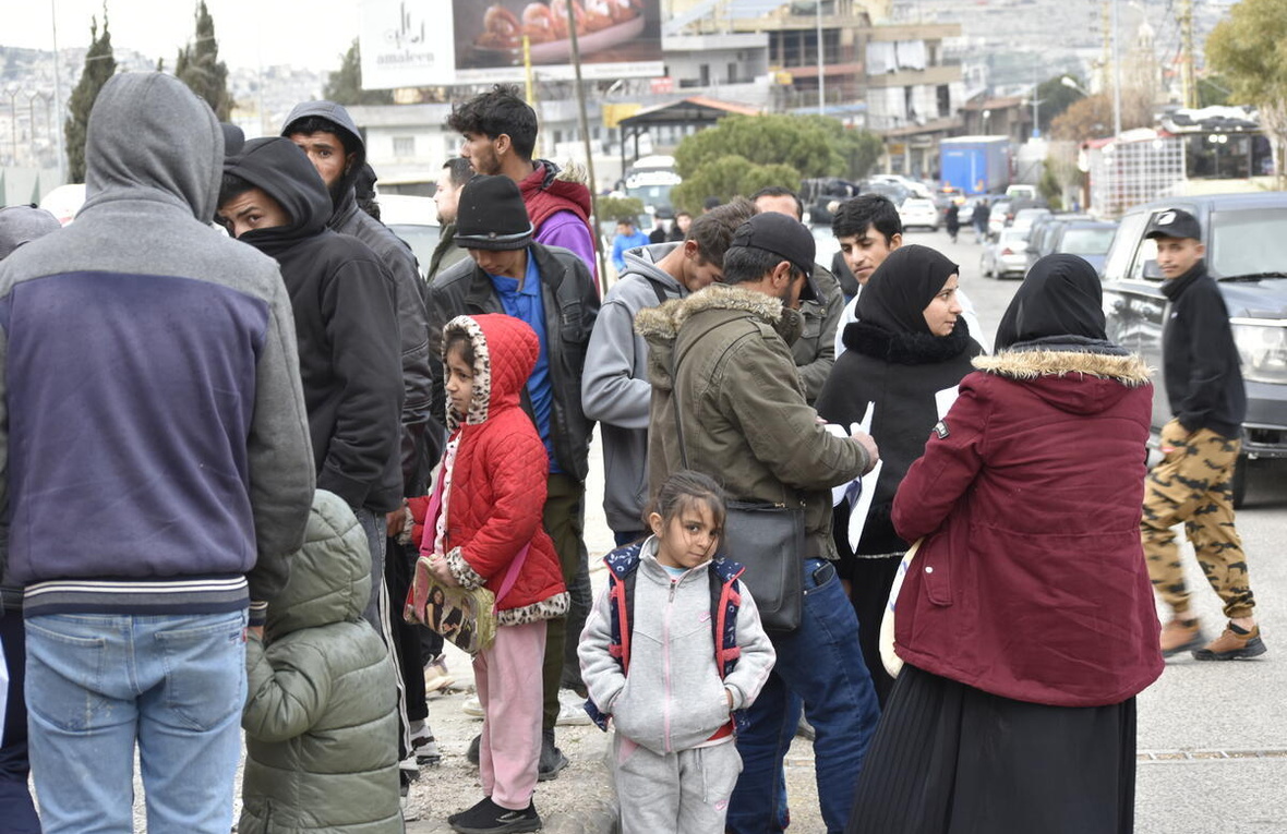 People gather outside at a border point.