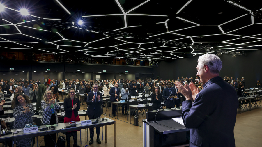 UN High Commissioner for Refugees, Filippo Grandi, stands and applauds during the closing session of the Global Refugee Forum. 