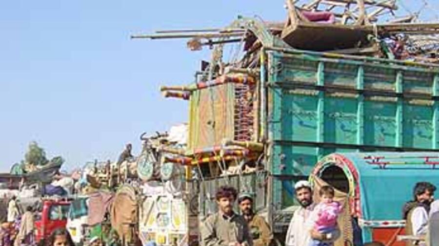 Afghan refugees on their way home Wednesday having registered at the Takhtabaig centre.