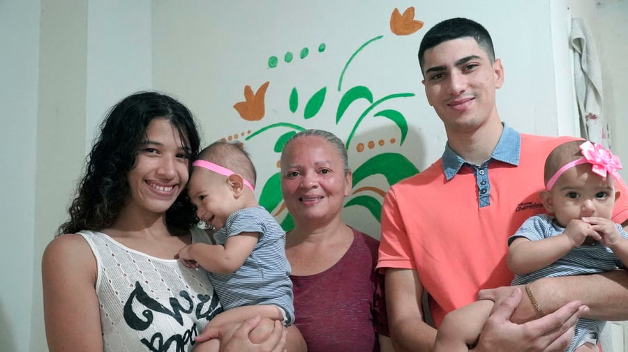 Venezuelan refugee María* poses for a portrait with her family in Medellín, Colombia. Kept inside by coronavirus stay-at-home orders, they are struggling to pay for basics like groceries and rent.