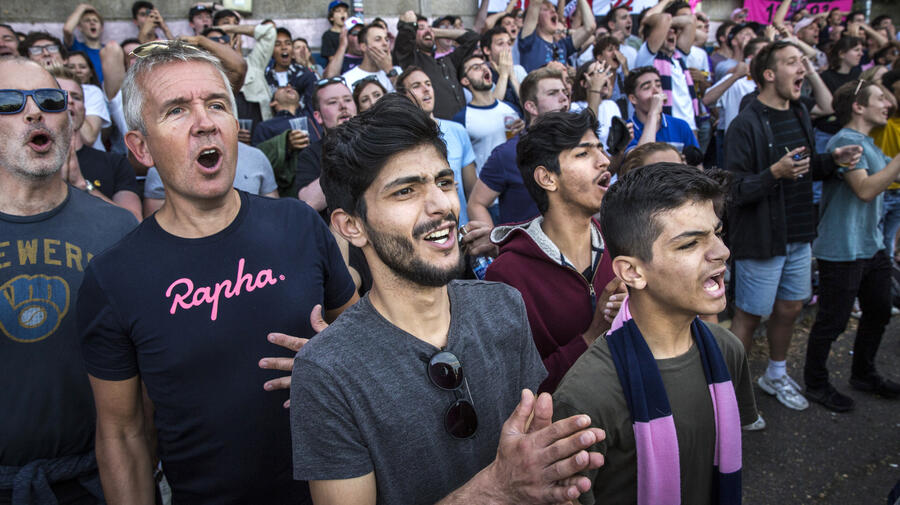 Al-Shaabin brothers, Mohammed, Islam, and Zain watch their local football team Dulwich Hamlet FC. They came to the UK as part of the community sponsorship programme, and UNHCR met them and their sponsors in their new home in Peckham, South London. 