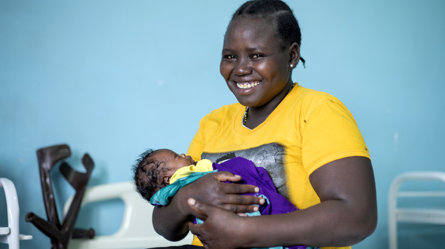 UNHCR UN Refugee Agency - South Sudanese refugee Lucia Amoo, 23, holds her baby boy, Kevin, who was born at Nalemsokon health clinic in Kakuma camp, Kenya, during the pandemic.