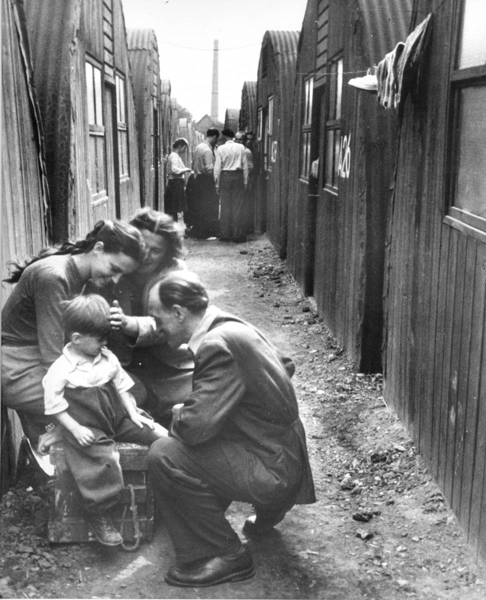 Black and white photo of refugee family in a camp in Europe