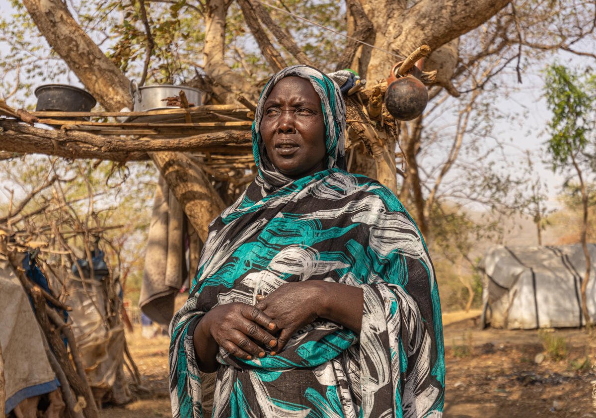 A Sudanese woman in front of a shelter