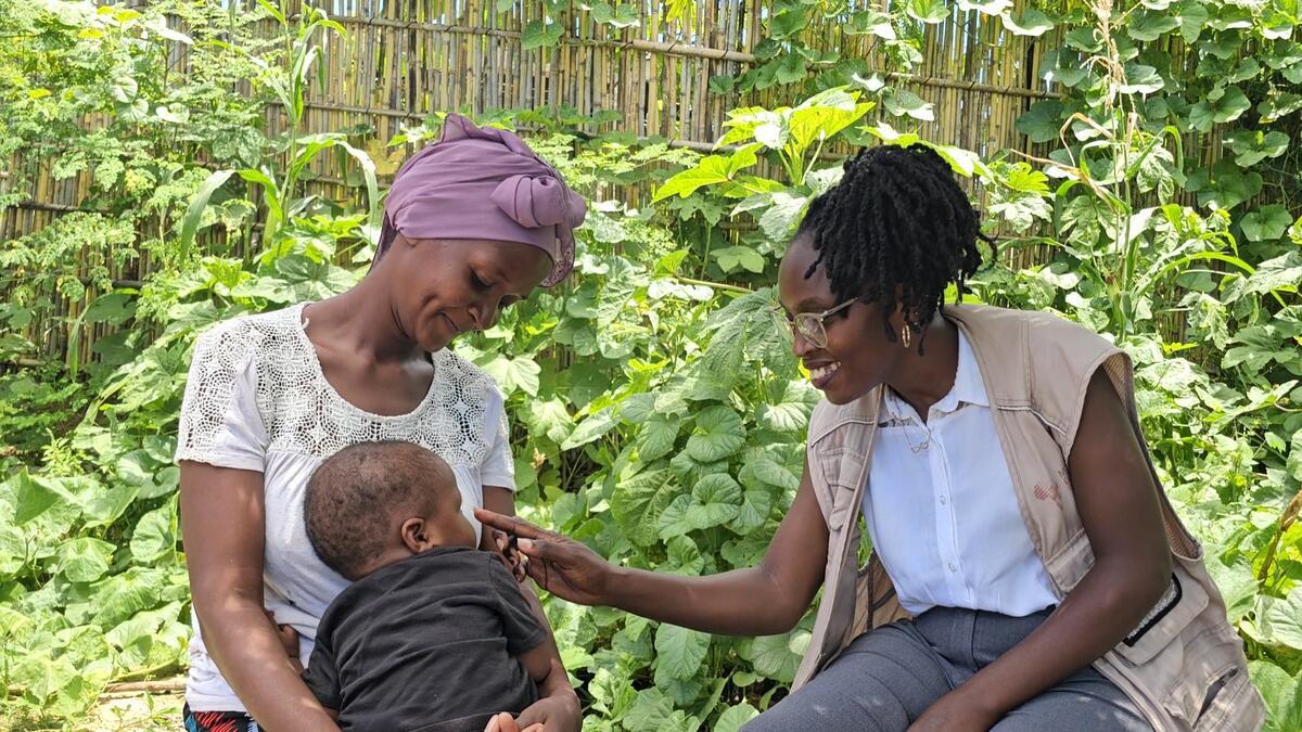 Psychologist Ancila shares a joyful moment with Viaze Abudo and her baby.
