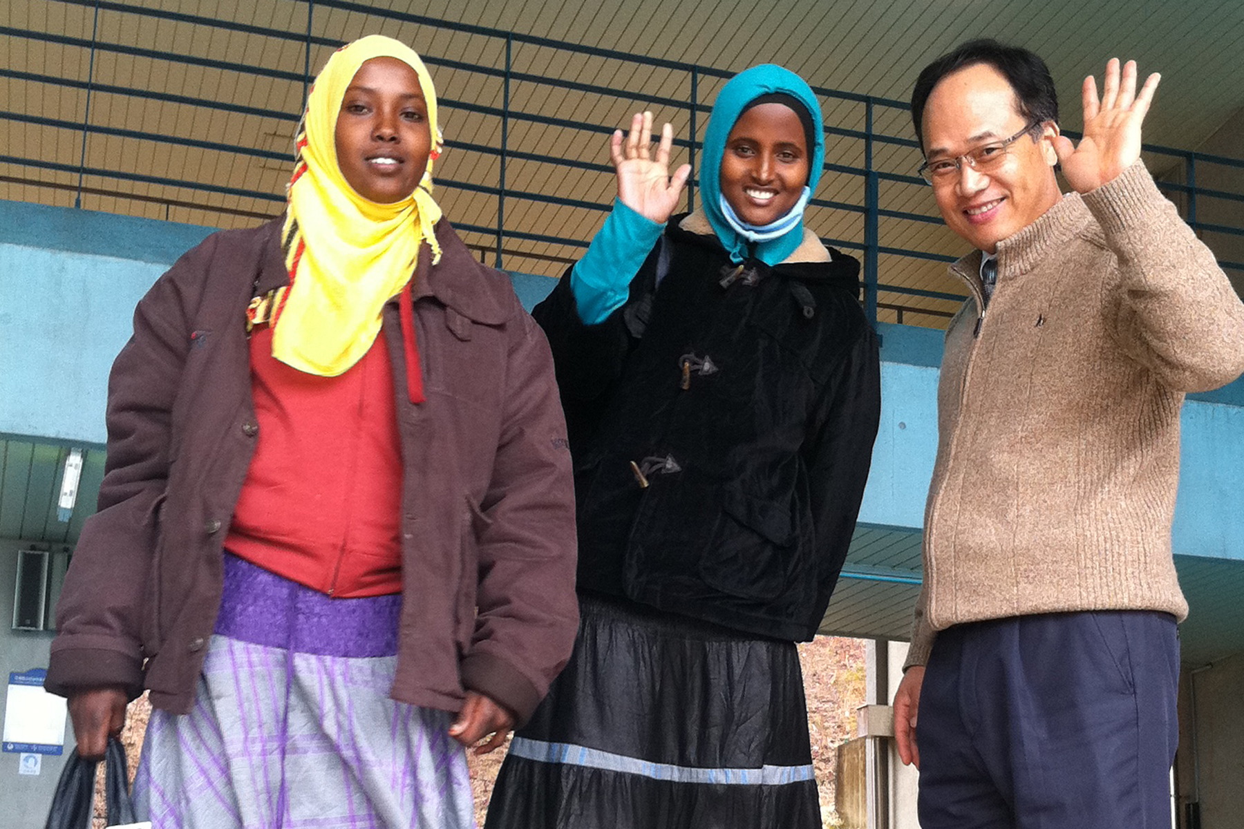 Nasra (left in yellow scarf) with fellow refugee Farah and a teacher at a language school in Iksan, South Korea.
