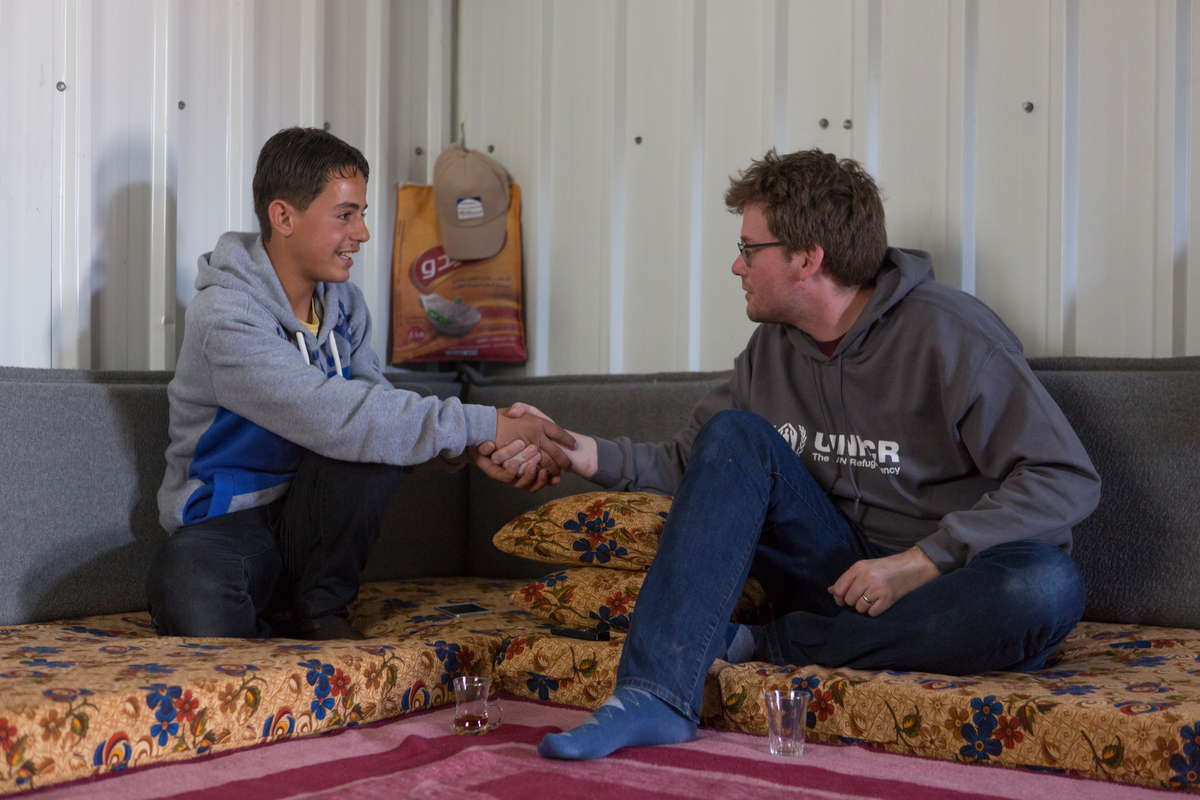 Jordan. UNHCR High Profile Supporter John Green meets Syrian refugee Hussam and his family in Azraq refugee camp