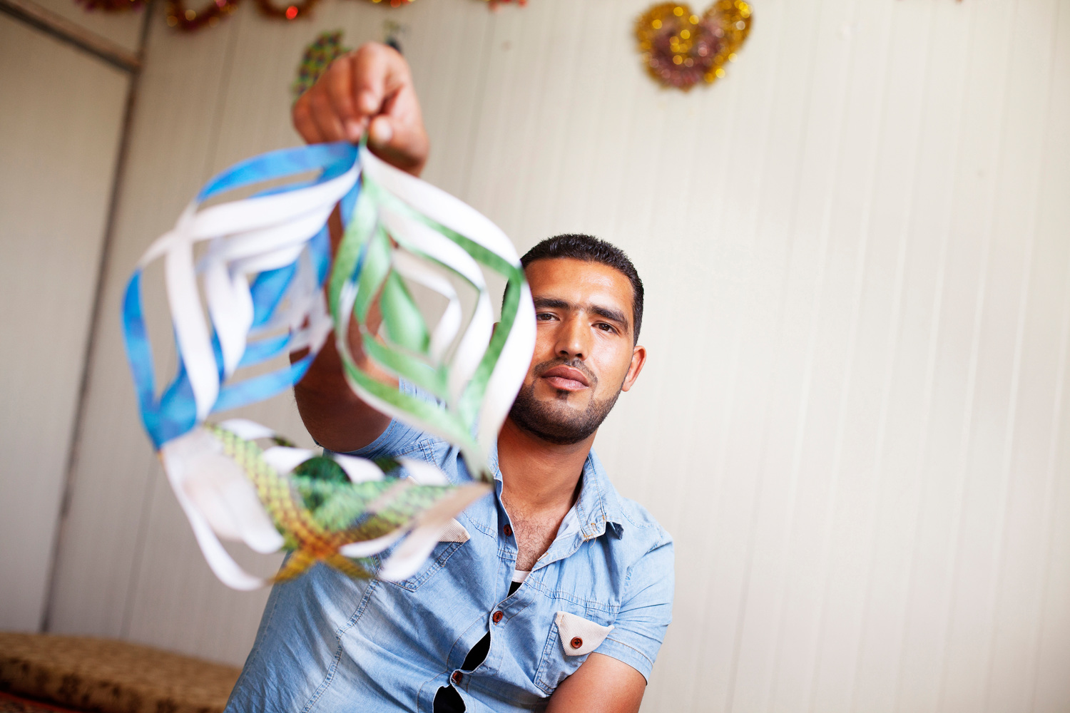 Jordan. 25-year-old Fadi Al Wali teaches origami to special needs children and other children at Za'atari refugee camp.
