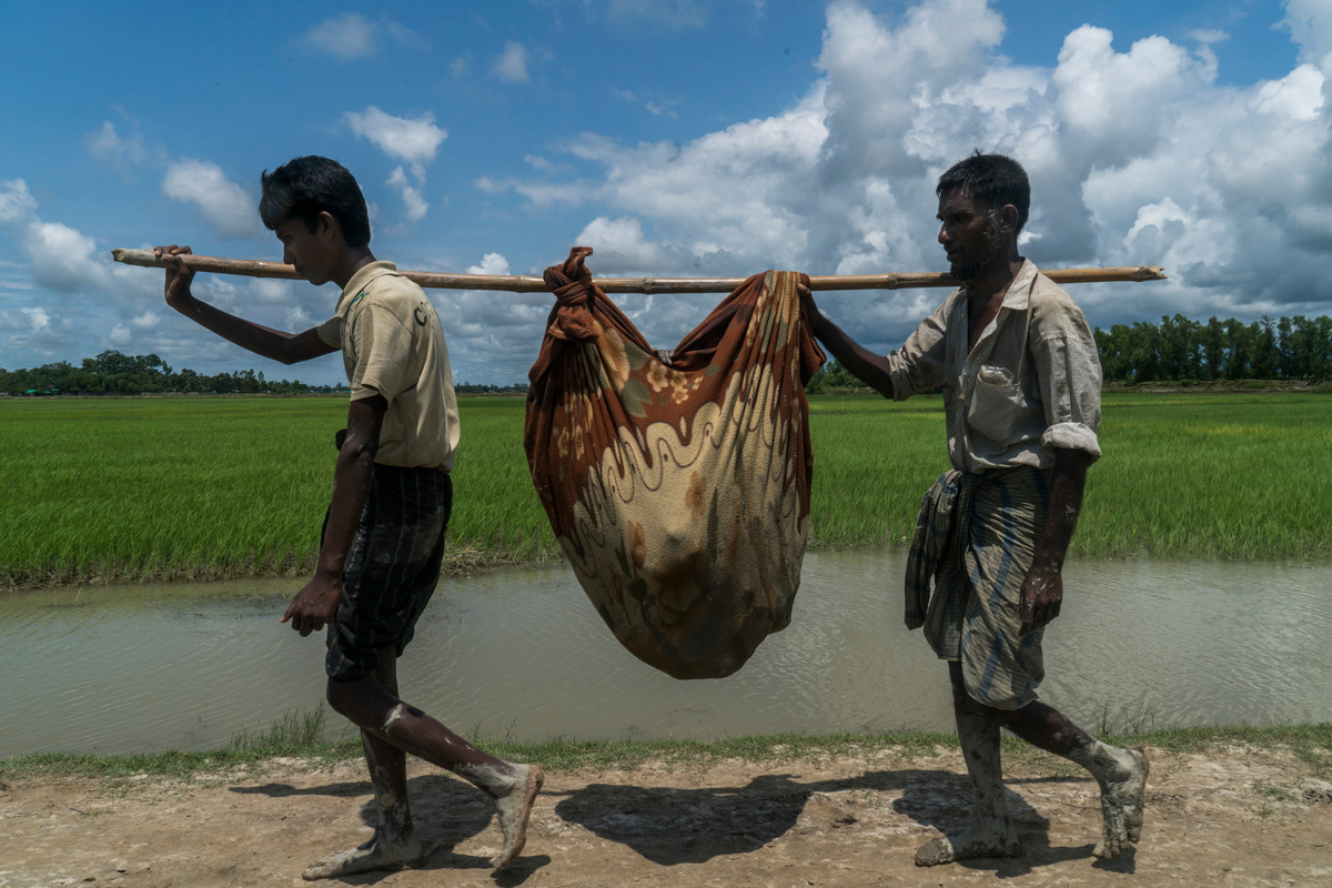 Bangladesh. An elderly Rohingya refugee is carried across the border