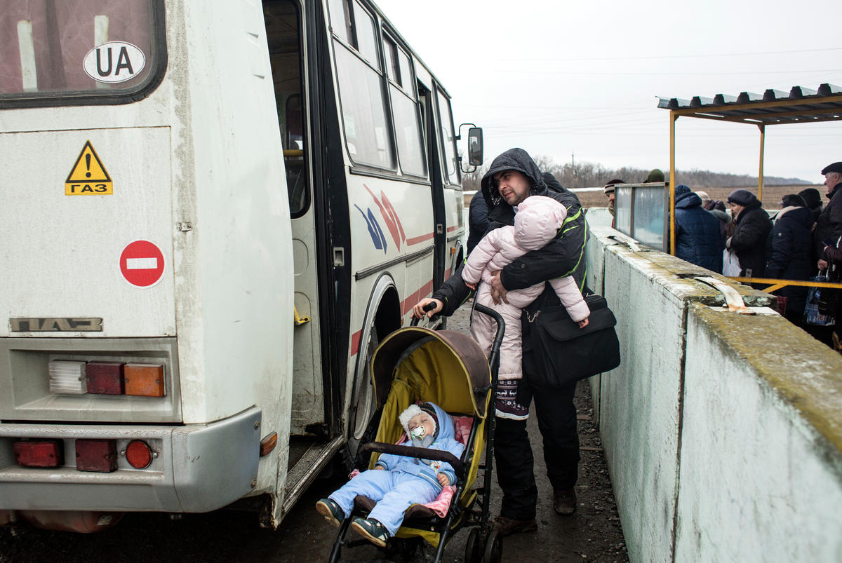 Ukraine. Freedom of movement. People are waiting in a line to cross the border at the crossing checkpoint in Mariinka, as they travel from the government controlled area to the non-government controlled area.