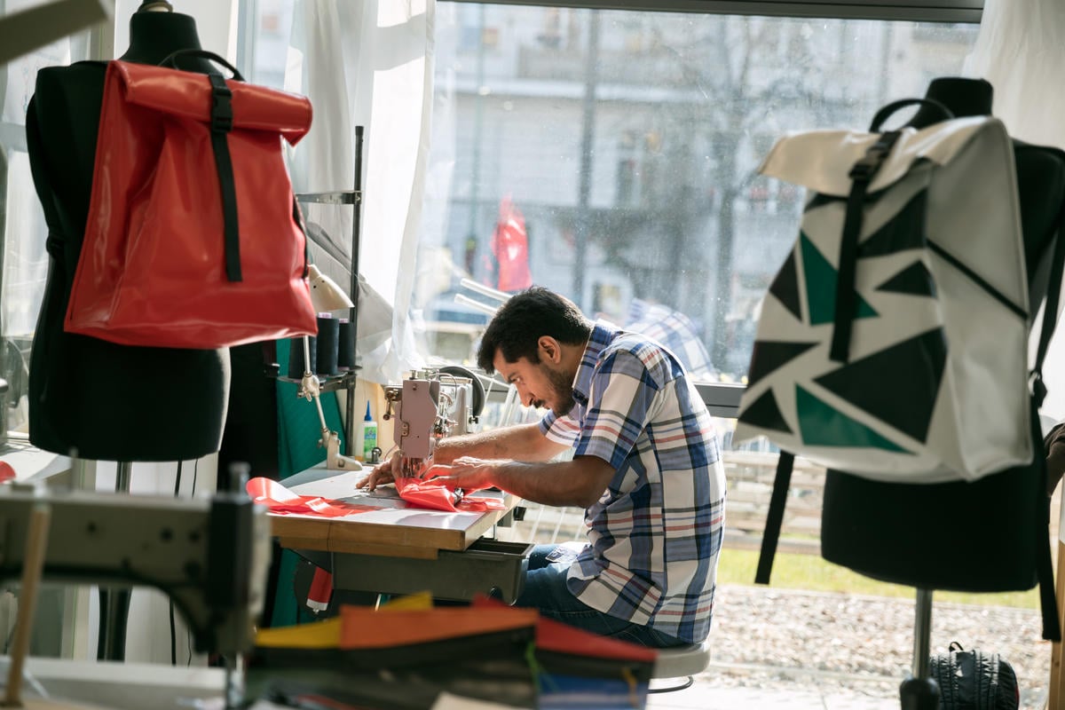 Germany. A non-profit initiative is employing newcomers to upcycle broken refugee boats into thought-provoking products.
