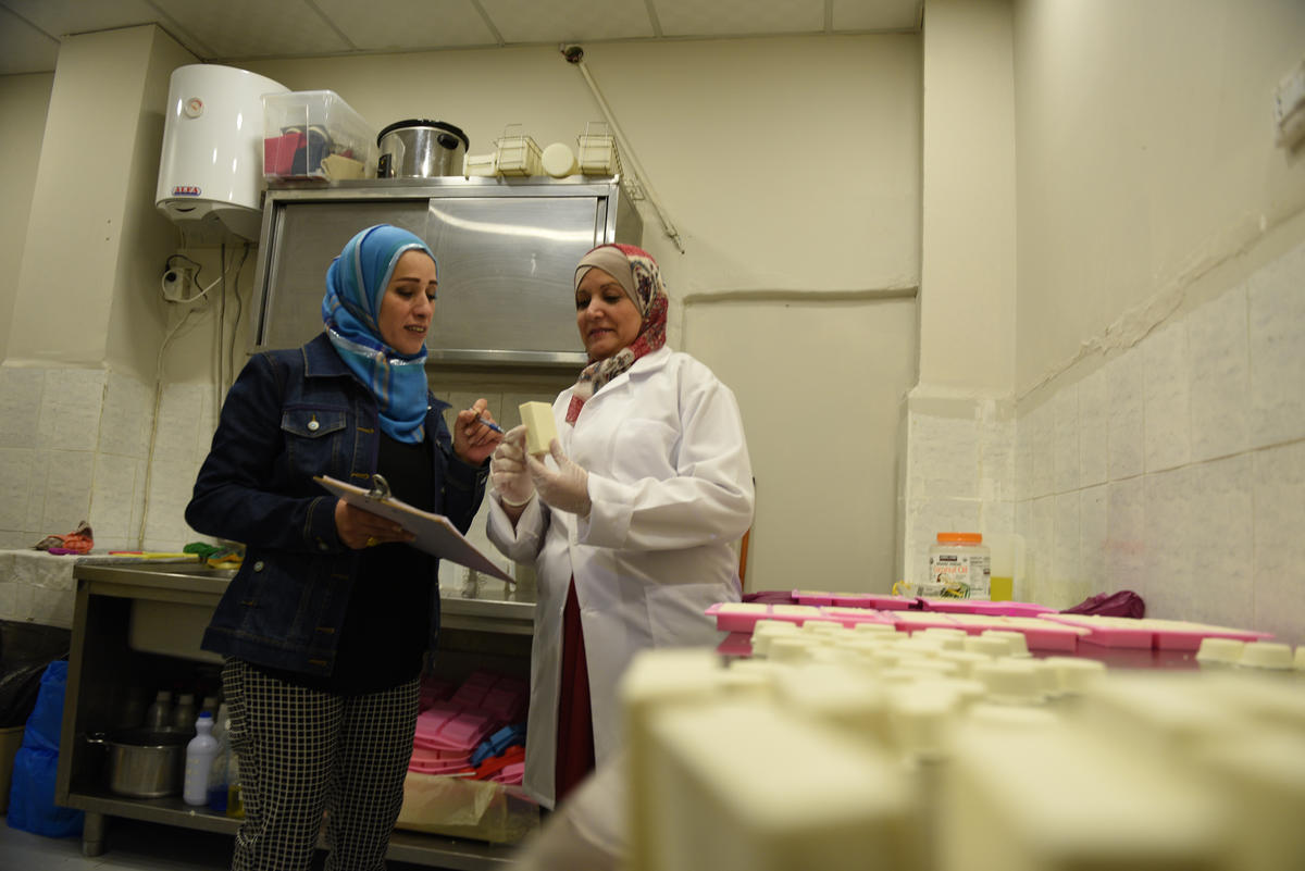 Jordanian employee Susan (left) helps Najwa to inspect the products before packaging.
