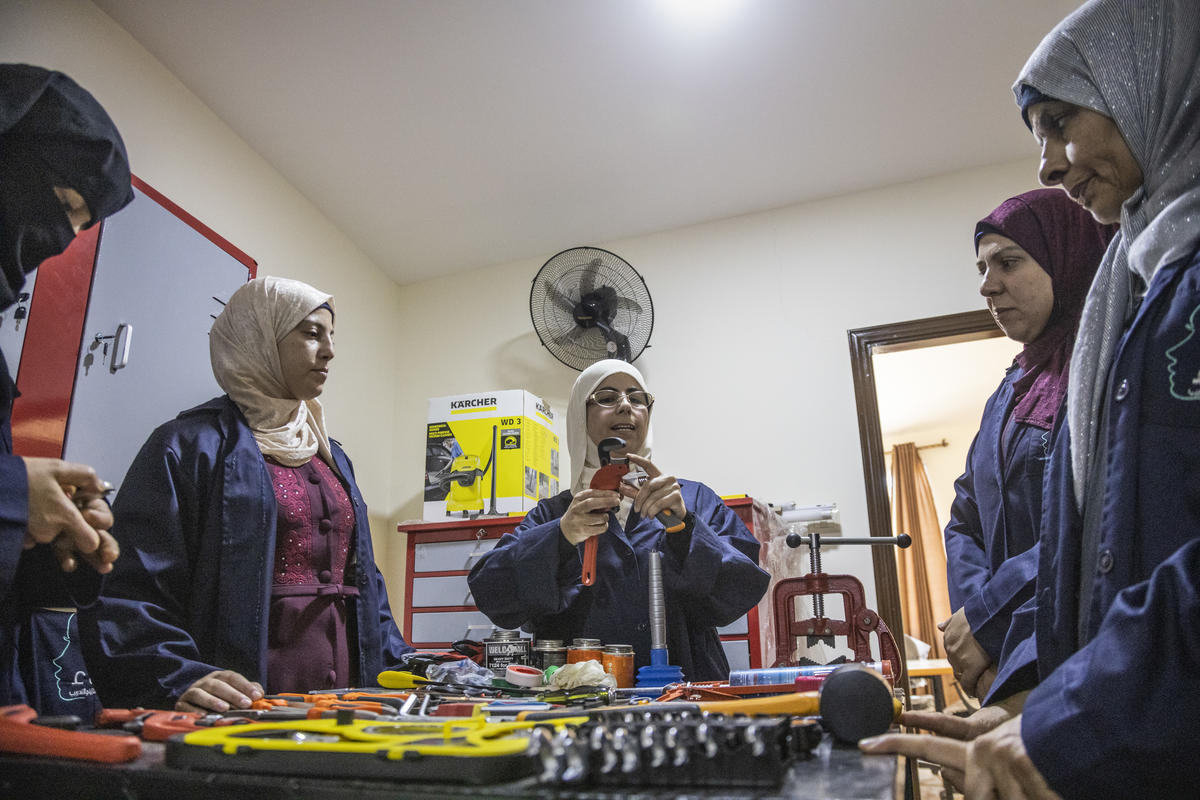 Jordan. Female plumber teaches refugees her trade