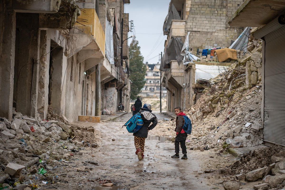 Syria. Civilians walk through the ruins of Aleppo