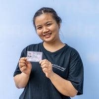 Naw Aung Shaw Paw, a refugee from Myanmar living in Ratchaburi, Thailand, displays her new government-issued identity card.