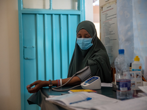 A woman has her blood pressure taken in a health clinic
