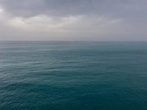 A view of the sea with dark clouds on the horizon