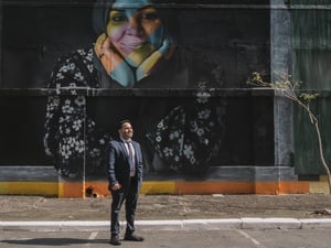 Abdul Jarour standing in front of a mural.