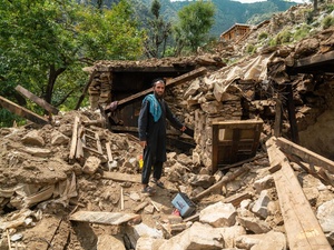 A man points at the rubble of his home following an earthquake in Kunar province, eastern Afghanistan.