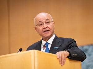 Barham Salih delivers a speech from a podium.