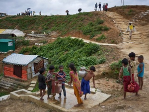 Bangladesh. Rohingya refugees fill containers at a water well in Kutupalong settlement