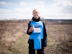 Ukraine. A female deminer in partially cleared minefield in the Donbas area