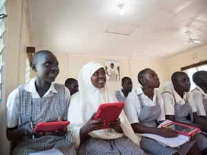 Kenya. Mary and Mumina use tablets in Class 8 at Angelina Jolie School